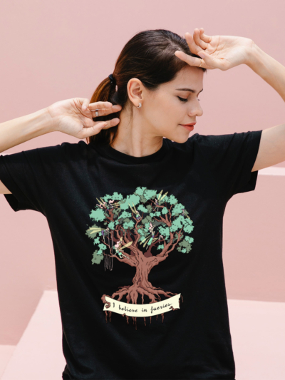 a woman wearing a black t-shirt with the I believe in fairies design by Natalia Salvador